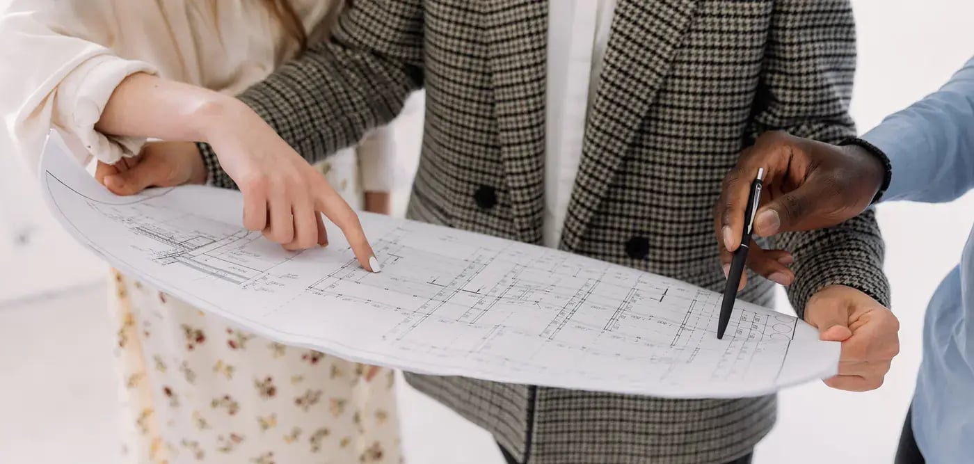 Clients and designer reviewing cottage plans